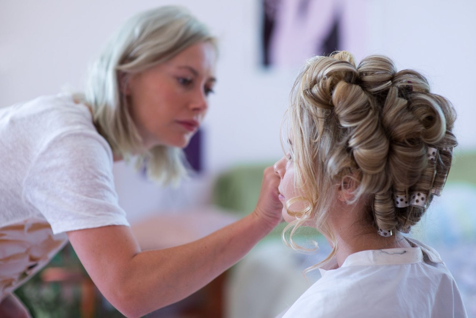 makeup artist preparing bride before the wedding in a morning; hair;salon;stylist;make;up;girl;