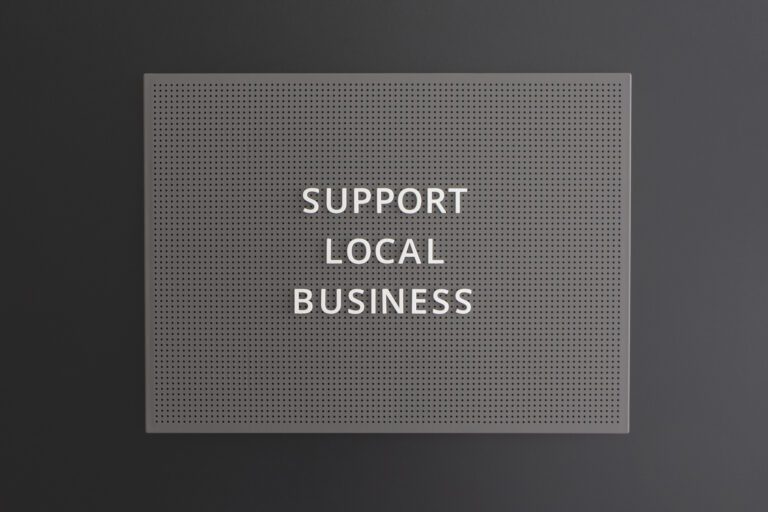 Support Local Business text written on blackboard on black background